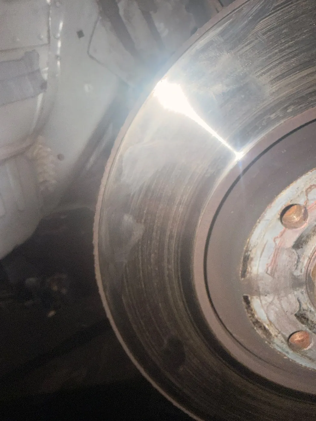 Close-up of a brake disc on a vehicle being worked on by Connor Waldron