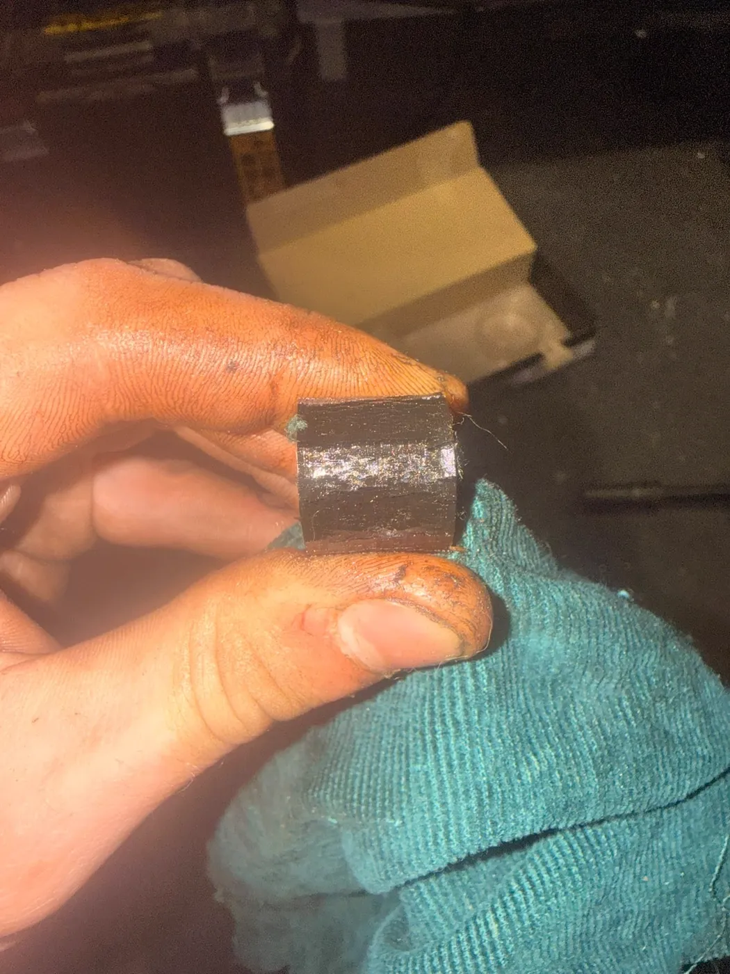 Connor Waldron holding a removed vehicle component to inspect it